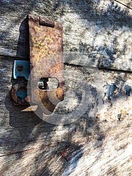 Old wooden box with rusty padlock photo